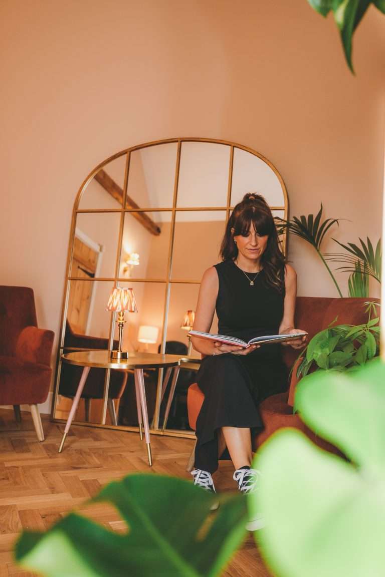 Nikki sits in her Norwich based health clinic journalling